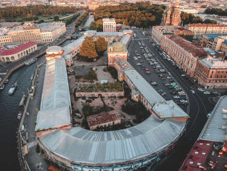 Aerial photo of the city center, the roofs of old houses. River boats. Russia, St. Petersburg.