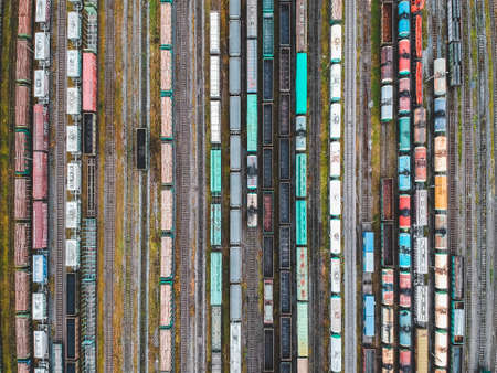 Cargo trains. Aerial view of colorful freight trains on the railway station. Wagons with goods on...