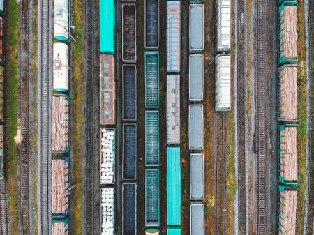 Cargo trains. Aerial view of colorful freight trains on the railway station. Wagons with goods on railroad. Heavy industry. Industrial conceptual scene with trains. View from flying drone. Russia, St. Petersburg.の写真素材