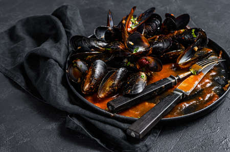 dirty plate with the remains of dinner, mussel shells. Black background. Top view.の写真素材