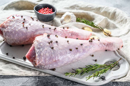 Raw Chicken leg with spices on a white cutting Board. Gray background. Top viewの写真素材