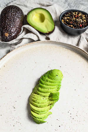 Sliced ripe avocado. Gray background. Top view.の写真素材