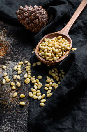 Pine nuts on stone table. Black background. Top view.の写真素材