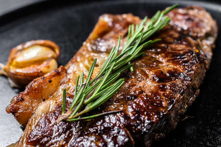 Beef New York strip steak on black background. Space for text. Marble premium beef. Close up