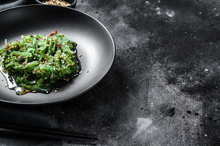 healthy seaweed chuka salad with greens. Black background. Top view. Copy space.の写真素材