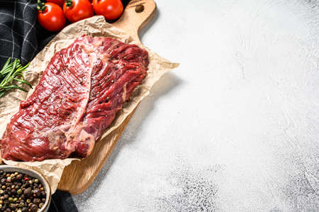 Flat iron steak, raw meat, marbled beef . Gray background. Top view. Copy space.の写真素材