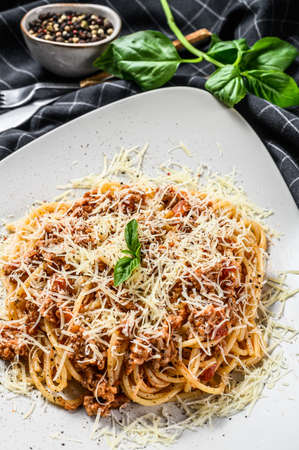 Traditional Italian spahgetti Bolognaise, Bolognese, pasta noodles. Basil, minced beef, tomatoes. Gray background. Top view.の写真素材
