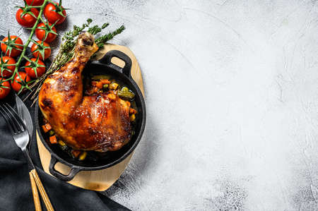 Cooked roasted chicken legs in baking pan. Grilled meat. Gray background. Top view. Copy space.の写真素材