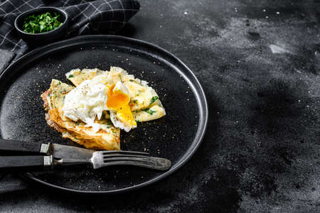 Plate of pancake stuffed with spinach and eggs. Black background. Top view. Copy space.の写真素材