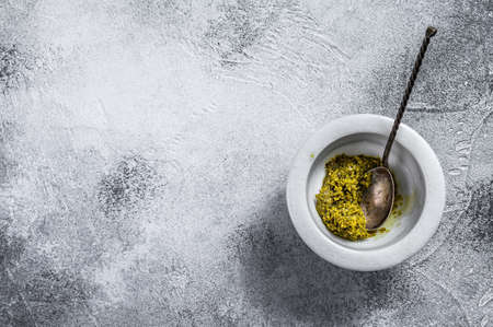 Italian Pesto in marble mortar. Space for text. Gray background.の写真素材