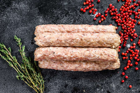 Close up of fresh raw pork kebabs. Black background. Top view.の写真素材