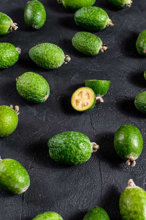 Background of green feijoa. Black background. Top viewの写真素材