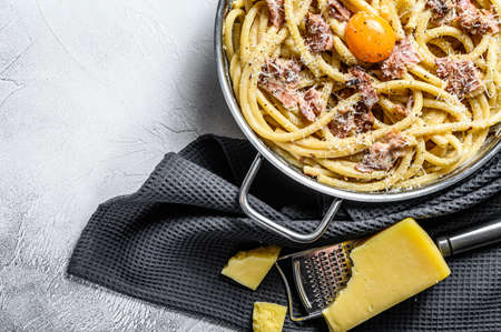 Pasta Carbonara, bucatini in the pan. Gray background. Top view. Copy space.の写真素材