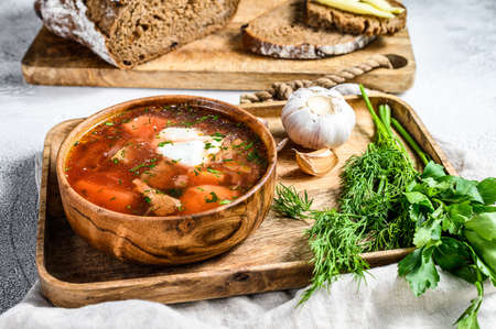 National Russian and Ukrainian Borsch beetroot soup in a wooden bowl. Gray background. Top view.