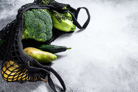 reusable bag for products with vegetables. Eco friendly, plastic free. Gray background. Top view....