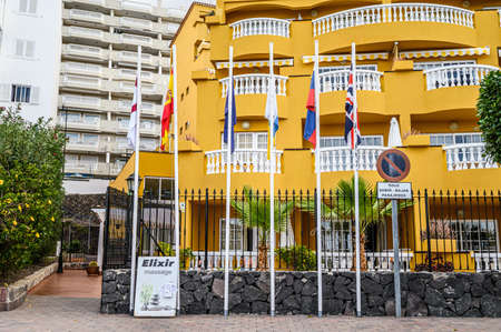 View of a large multi-storey hotel in a mountain town. Selective focus. 20.01.2020 Los Gigantes, Tenerife.のeditorial素材