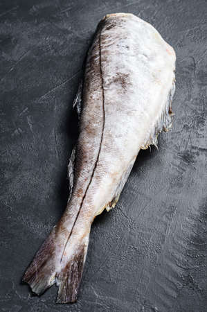 Fresh haddock fish carcass. Black background. Top view.