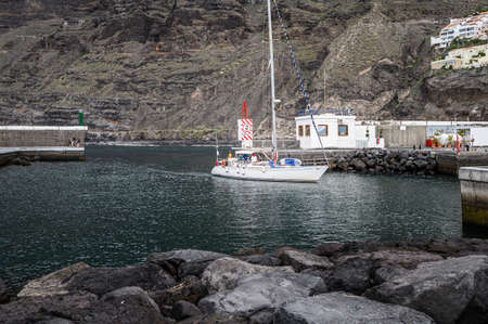 The yacht with passengers enters the port. Selective focus. 20.01.2020 Los Gigantes, Tenerife.のeditorial素材