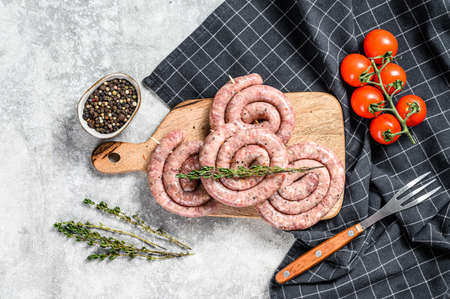 Traditional raw spiral pork sausages. Gray background. Top view.の写真素材