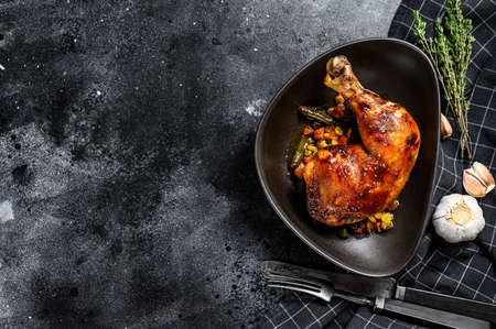 Cooked roasted chicken legs. Grilled meat. Blacked background. Top view. Copy space.の写真素材