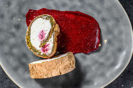 Homemade strawberry shortcake cake roll with cream cheese. Black background. Top view. Copy space.の写真素材