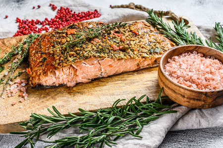 homemade hot smoked salmon fillet on a cutting Board. trout. Gray background, top view.の写真素材