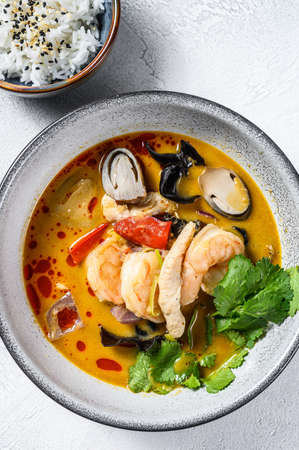 Tom Yum soup with shrimps and coconut milk. Gray background. Top viewの写真素材
