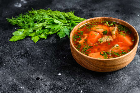 National Russian and Ukrainian Borsch beetroot soup in a wooden bowl. Black background. Top view. Space for text.の写真素材