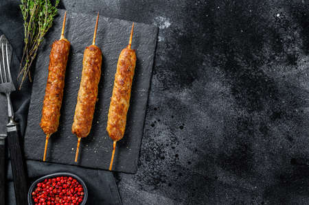 Lula kebab. Shish kebab on a stick, from ground beef meat. Black background. Top view. Copy space.の写真素材