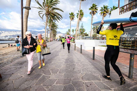 surfers on the stone shore of the ocean, surf school, extreme sports. 07.01.2020 Tenerife, Canary Islands.のeditorial素材