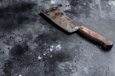 Vintage butcher cleaver with wooden handle. Black background. Top view. Copy space.