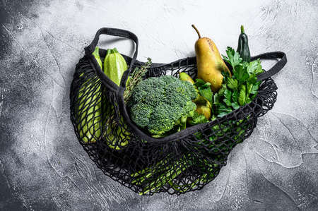 reusable bag for products with vegetables. Eco friendly, plastic free. Gray background. Top view. Copy space.の写真素材