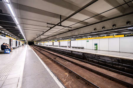 Interior of underground metro station. People on the platform. 03.01.2020 Barcelona, Spain.