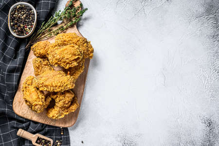 Breaded Crispy fried kentucky chicken wings, tasty dinner. Gray background. Top view. Copy space.の写真素材