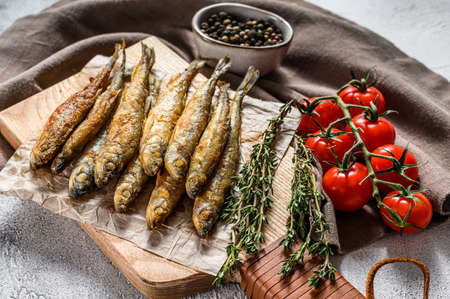 Grilled smelt fish. Delicious appetizer. Gray background. Top view.の写真素材