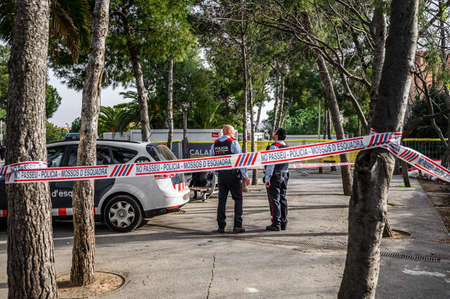 Police tape wrapped around a tree to limit the perimeter of a crime scene or a suspected bomb site....