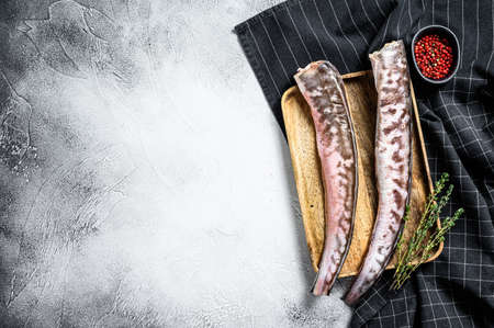 Raw king klip, congrio fish with cooking ingredients. gray background. Top view. Copy space.
