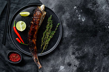 Grilled king klip, congrio with teriyaki sauce. Black background. Top view. Copy spaceの写真素材