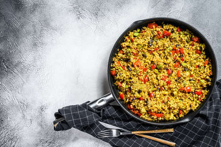 Cooked bulgur with vegetables in a pan. Gray background. Top view. Copy space.の写真素材