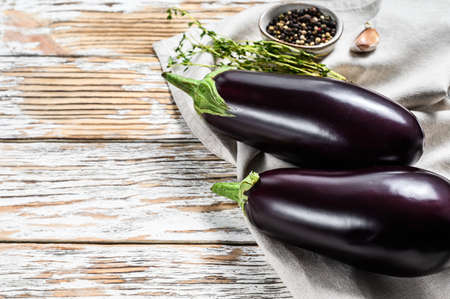 Raw purple eggplant. Organic vegetables. White background. Top view. Copy space.の写真素材
