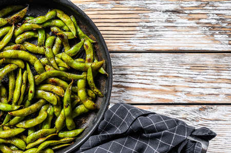 Steamed Edamame Bean, Green Soybean in a pan, East Asian Cuisine. White background. Top view. Copy space.の写真素材