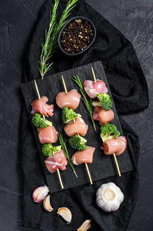 Raw chicken kebab with broccoli. Black background. Top view.の写真素材