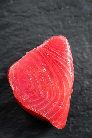 Raw fillet steak tuna. Black background. Top view. Close up.の写真素材