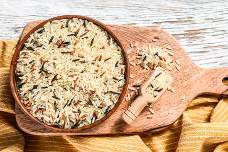 Jasmine, Brown, Red and Black rice in a bowl. Mixed rice and Riceberry. White background. Top view.の写真素材