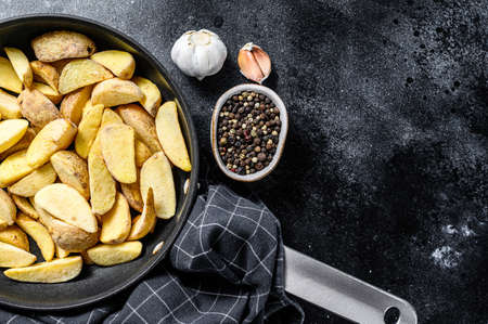 Frozen French Fries potato wedges. Black background. Top view. Copy space.の写真素材