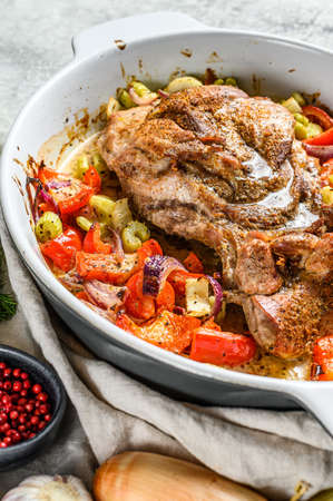 Baked Turkey thigh fillet with vegetables in a baking dish. Gray background. Top view.の写真素材