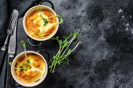 Cheese omelette , omelet with microgreens in a pan. Black background. Top view. Copy space.の写真素材