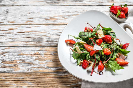 Salad with Camembert, strawberries, nuts, chard and arugula. White background. Top view. Copy space.の写真素材