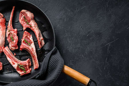 Rack of lamb , raw meat with bone. Organic lamb meat. Black background. Top view. Copy space.の写真素材