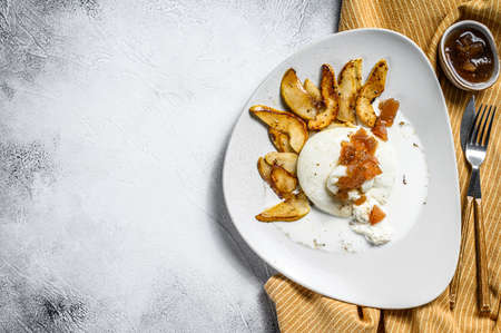 Burrata cheese with baked pear and pear marmalade. Gray background. Top view. Copy space.の写真素材